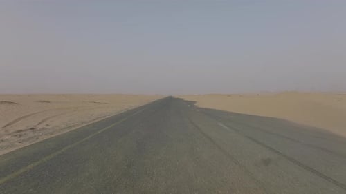 Aerial video of a sand covered road in the deserts of Dubai