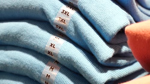 Folded Sweaters with Size Labels in Store