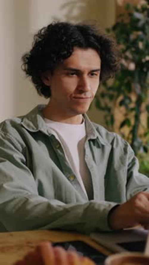 Man working on a laptop while sitting at table