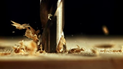 Drill Bit Drilling into Wood at Close Range