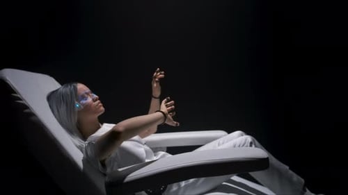 Woman Lying in Chair with Futuristic Glasses