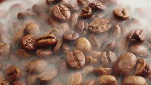 Roasting Coffee Beans with Smoke on Dark Background Close Up Arabica Robusta Colombian Beans