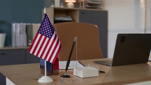 American Flag Placed On Desk In An Office