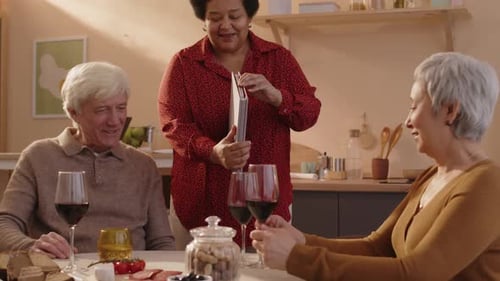 Friends Share Memories Over Wine in Kitchen