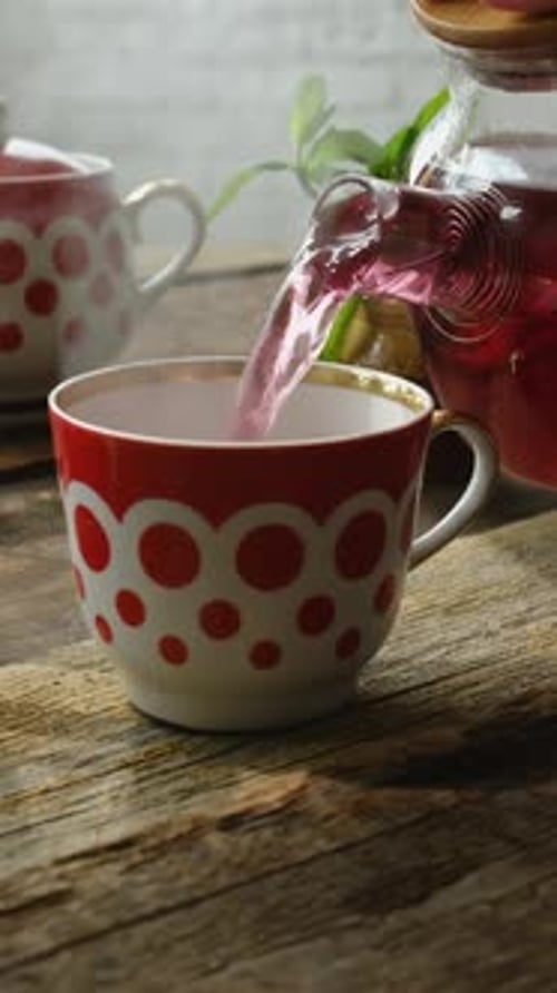 Vertical Video Tea Drinking Pouring Hot Red Hibiscus Tea Into Mug