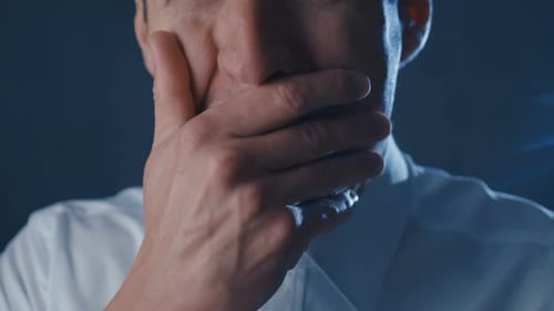Distressed Man Covers Face with Hand in Anguish