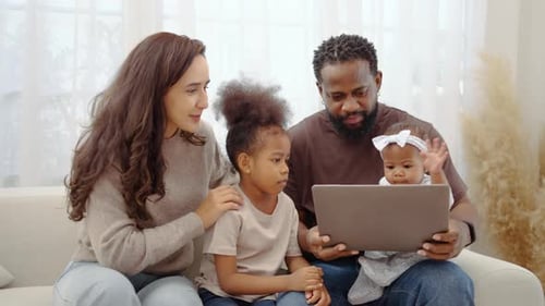 Family of Four Watching Laptop at Home