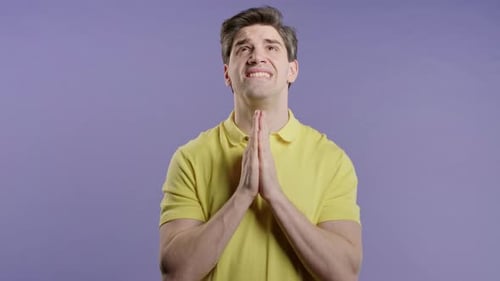 Man Praying or Pleading in Front of Camera
