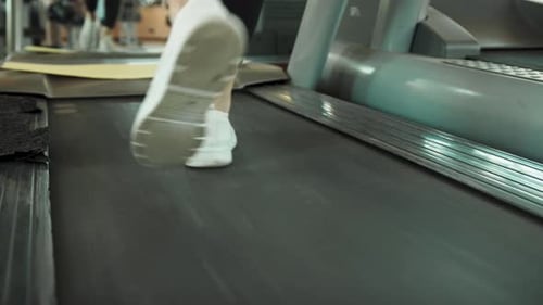 White Shoes On The Gym Treadmill