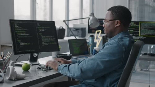 Black Male Programmer Coding on Computer in Office