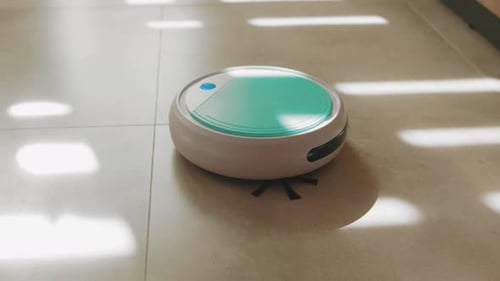 Robotic Vacuum Cleaning Tile Floor in Sunlight