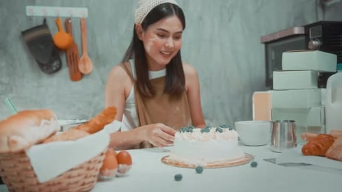 Young beautiful woman is baking in her kitchen