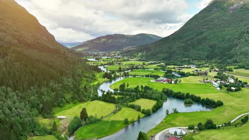 Aerial of river winding through farmland in Norway.