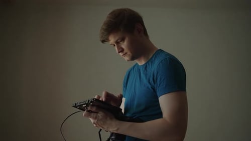 Professional Filmmaker Concentrating on Setting Up and Calibrating External Monitor Checking