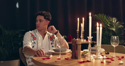 Man, dinner and waiting for date at restaurant with romantic decoration