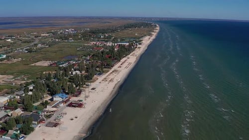 Beautiful flight in summer over the beach. People are resting near the sea.