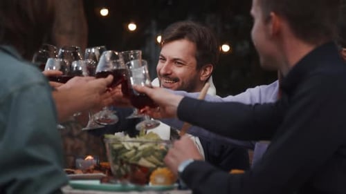 Friends Toasting with Wine at Dinner Party
