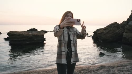Happy Beautiful Redhaired Woman Make Picture on Smartphone at Beach Laughing and Smiling to Camera