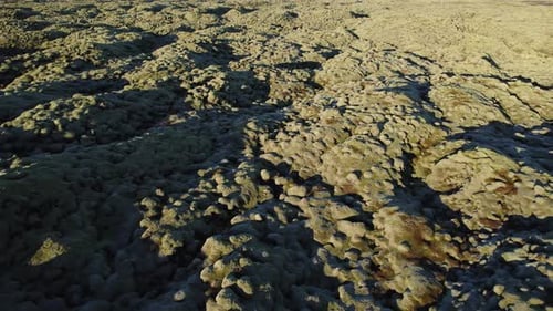 Cinematic aerial dolly of infinity lava fields in Iceland, sunset