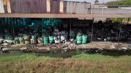 Polluted Industrial Zone with Waste and Murky Canal