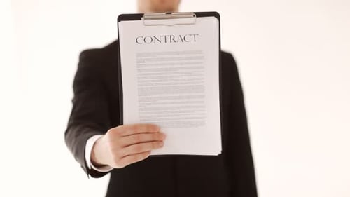 Businessman in suit showing contract for signature close up