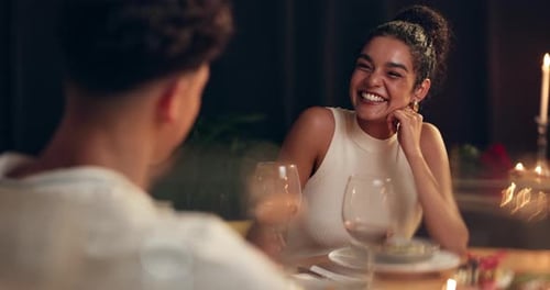 Happy, couple and talking on date at restaurant with romance, valentines day celebration