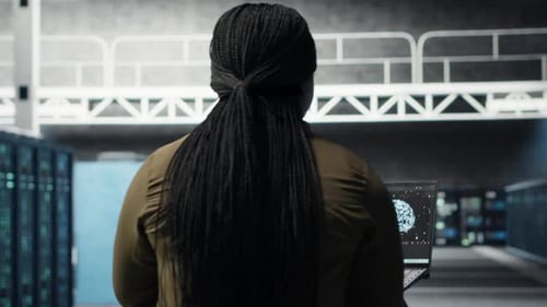 Engineer in Server Hub Using Laptop to Upgrade Rigs Using AI Deep Learning