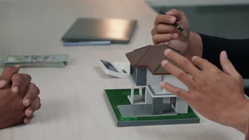 Business people seller explain and calculate to who buying real estate house properties.