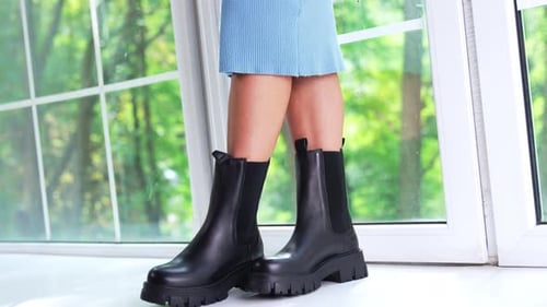 Woman in Black Platform Boots Posing by Window