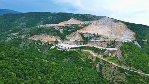 Natural Quarry is Located Near Road Against Backdrop of Rhodope Mountains and Hills with Forests and