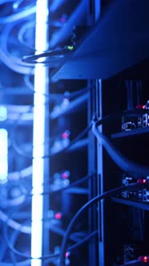 Data Center Team Inspecting Servers in Blue Light