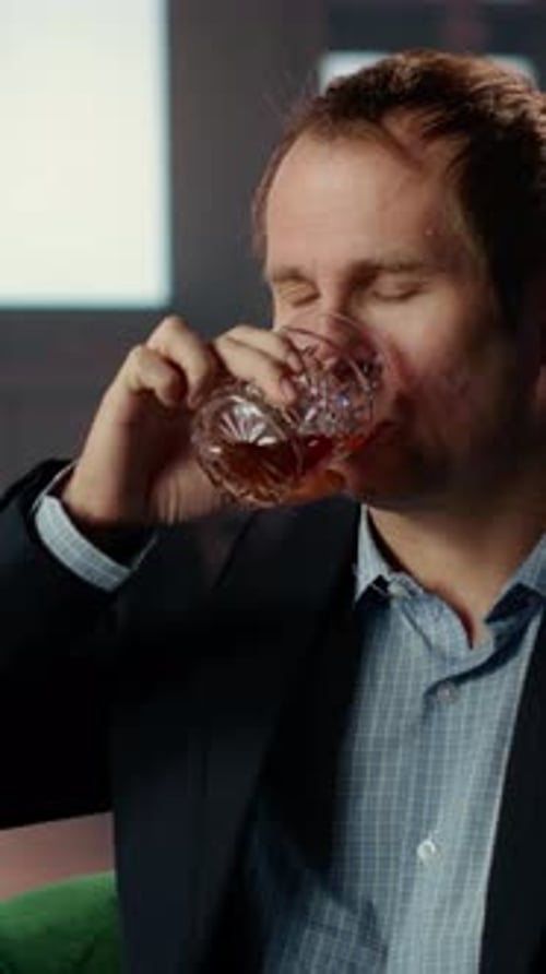 Vertical Video Old Money Classy Heir Drinking a Glass of Whiskey at Elite Social Club