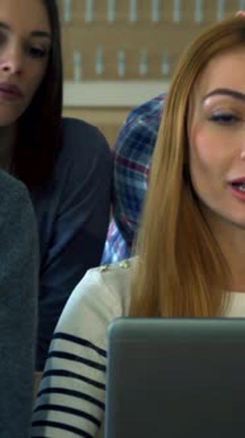 Engaged Male Student Points Pencil at Laptop Screen During Lecture