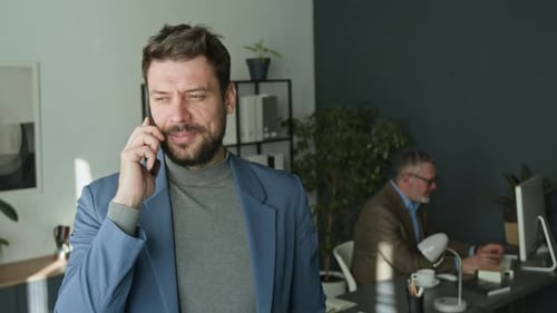 Businessman Speaking on Phone during Workday in Office