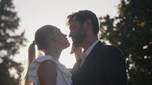 Portrait of Charming Man and Woman Newlyweds Outdoors Action Happy Wedding Couple in Summer Garden