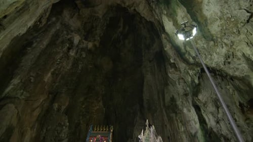 Visitors at the colorful Batu Caves temple, inside a massive limestone cave