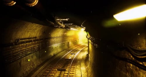 Exploring an Underground Tunnel with Railway Tracks and Glowing Lights