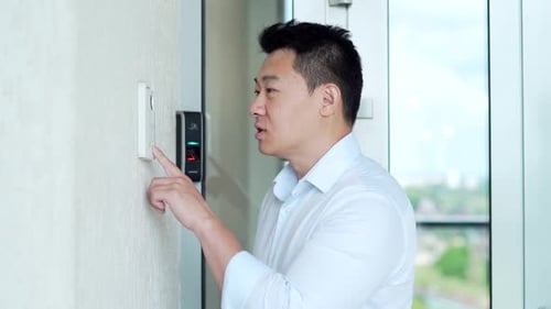 Man Interacting With Smart Home Device Indoors