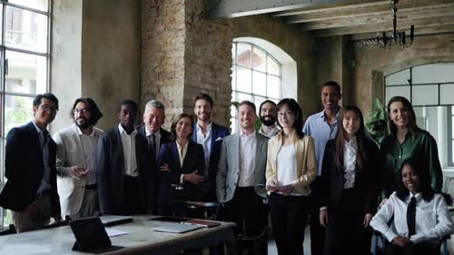 Multiracial group of business people smiling on camera inside office. Entrepreneur team