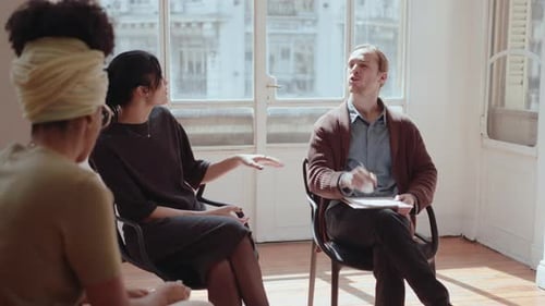 Group Therapy Participants Talking with Psychologist in a Circle