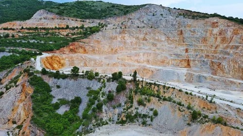 Natural Quarry is Located Near Road Against Backdrop of Rhodope Mountains and Hills with Forests and