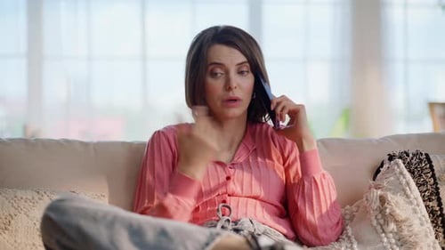 Woman Talking on Phone on Couch at Home