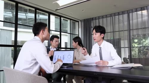 Team Meeting in Modern Office Discusses Sales Data