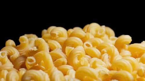 Heap of Uncooked Cavatappi Pasta Close Up