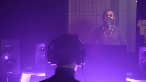 Sound Producer and Black Man Musician Recording a Song in the Studio