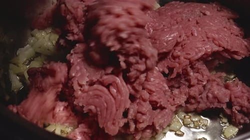 Person is Adding Minced Turkey Meat to a Saucepan, Chopped Onions are Sautéed in Pan - Steady Shot