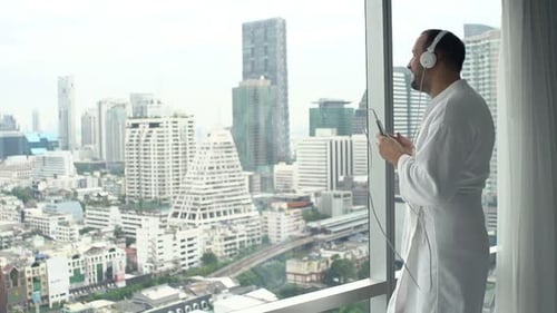 Man Listening to Music and Dancing Indoors