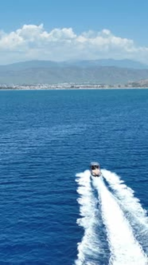 Speed boat cruising fast on summer sea