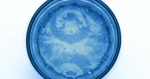 Blue Carbonated Soda Bubbling in Glass