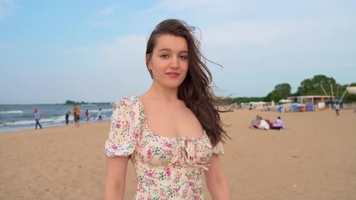 Happy Cheerful Young Woman Enjoying Life on Sandy Beach Summer Day with Blurred People on Background